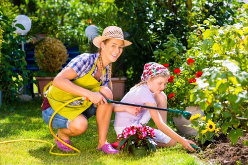 Crew using PPE and safety gear while maintaining a garden
