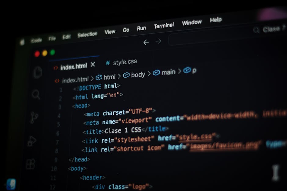 A close-up view of a computer screen displaying lines of colorful code, including variables, functions, and syntax highlighting. The blurred background suggests a workspace setting, indicating the per